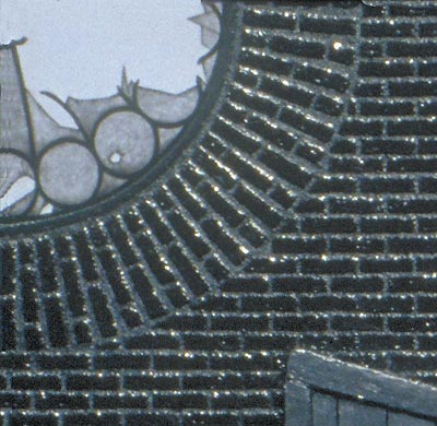 Detail of an apocalyptic vision, here focusing on the left window and surrounding masonry.